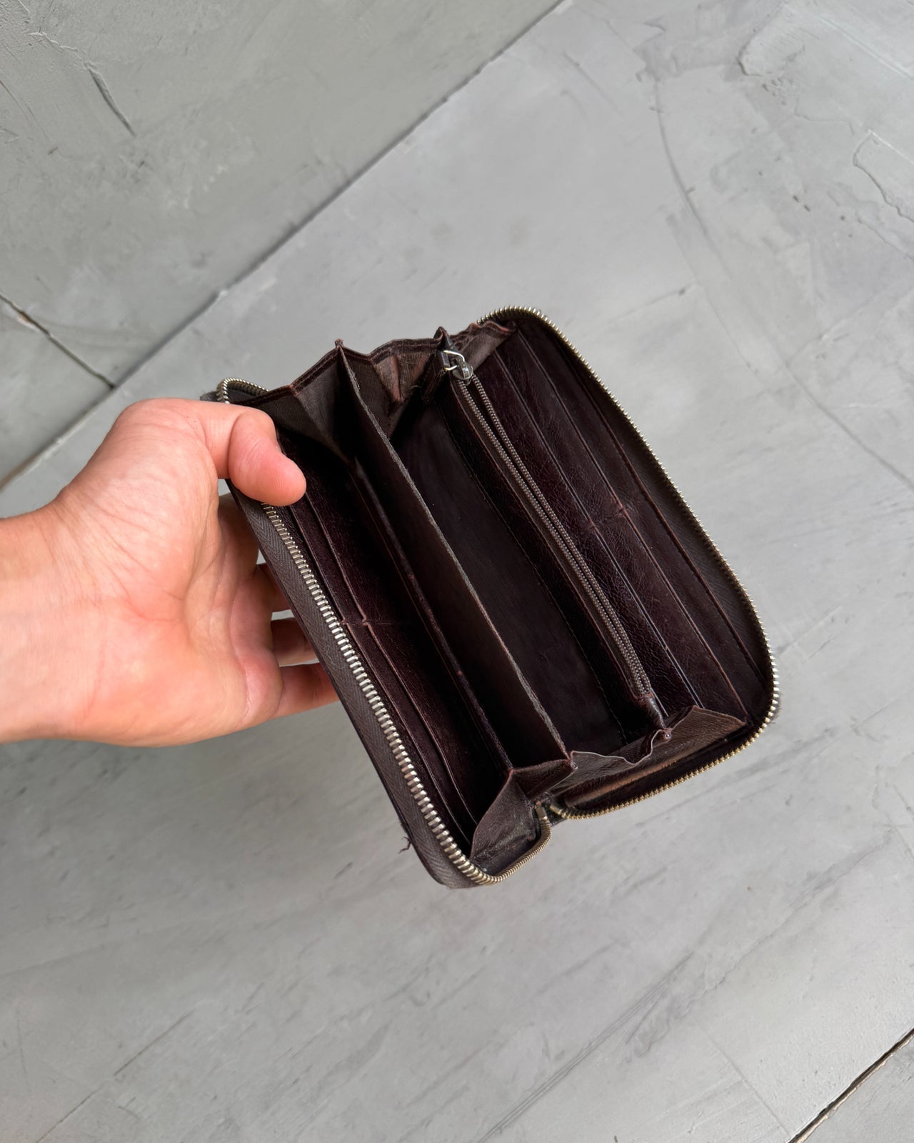 Yves Saint Laurent Leather Wallet-on a concrete background