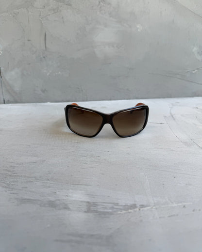 Prada Brown Sunglasses-on a concrete background