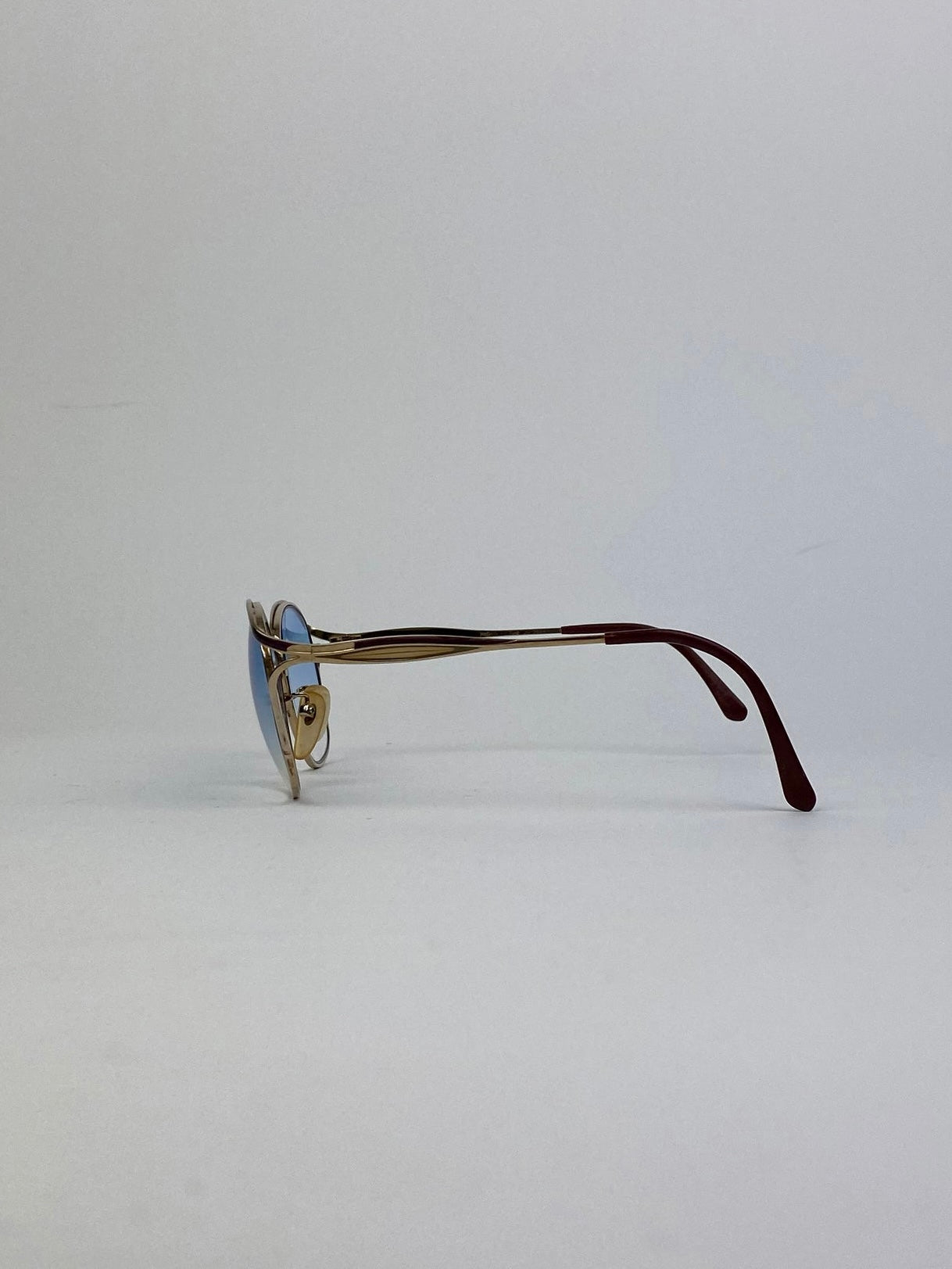 Yves Saint Laurent Paris round sunglasses with gold frames and dark lenses, stylish eyewear for a fashionable look.