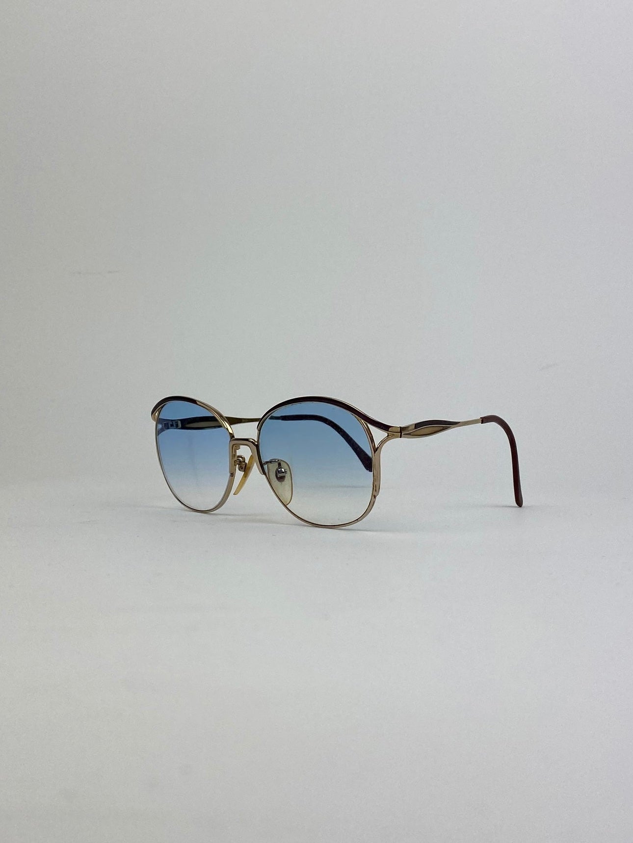 Yves Saint Laurent Paris round sunglasses with gold frames and dark lenses, stylish eyewear for a chic look