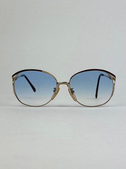 Yves Saint Laurent Paris round gold sunglasses with sleek metal frames and tinted lenses, stylish and fashionable eyewear.