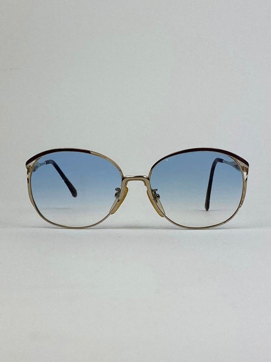 Yves Saint Laurent Paris round gold sunglasses with sleek metal frames and tinted lenses, stylish and fashionable eyewear.